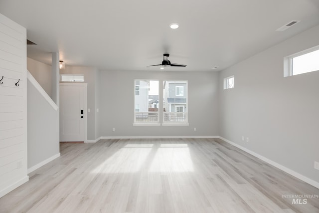 unfurnished living room with visible vents, baseboards, and light wood-style flooring