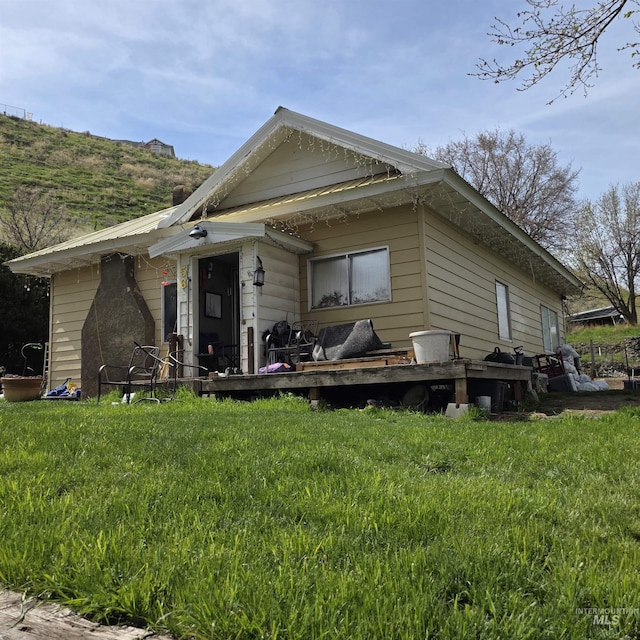 view of front of house with a front yard and a deck