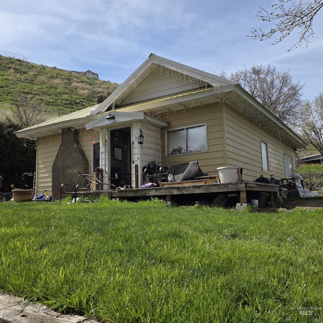 view of front of property with a front lawn and a wooden deck