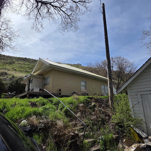 view of side of property featuring metal roof