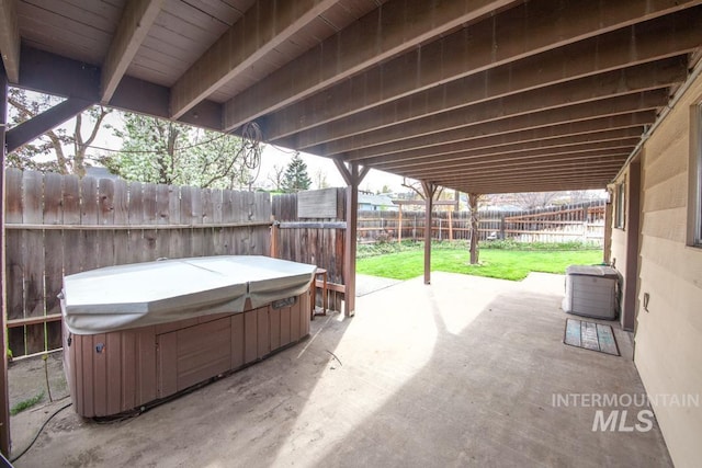 view of patio / terrace featuring a fenced backyard and a hot tub