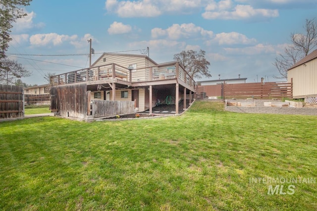 back of house with stairway, a fenced backyard, a yard, and a deck