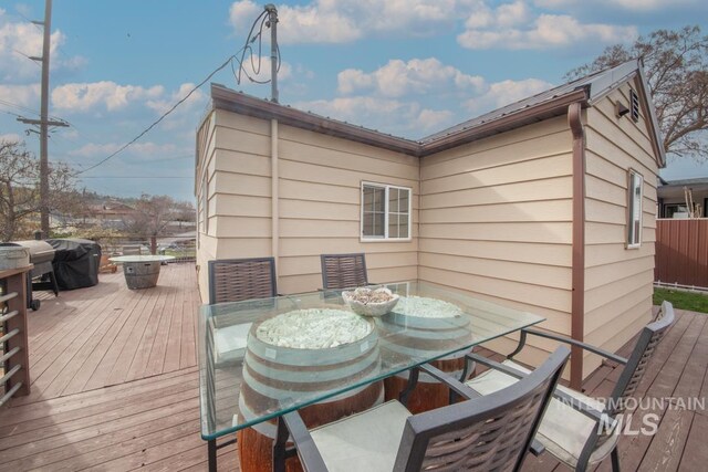 wooden terrace featuring outdoor dining area