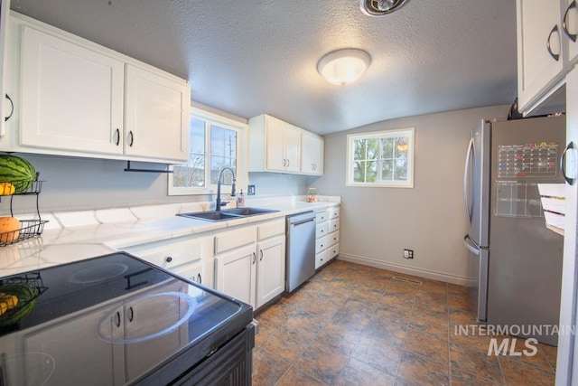 kitchen featuring dishwasher, a sink, white cabinetry, and black electric range