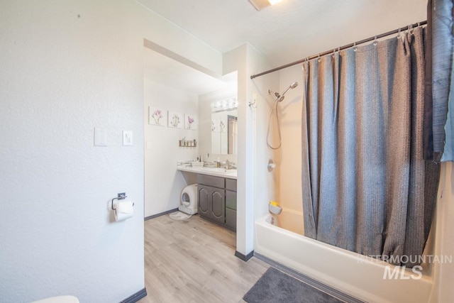 full bathroom featuring baseboards, shower / bath combo, wood finished floors, and vanity