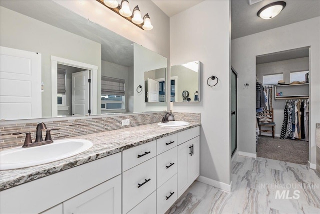 18272 N Wild Goose Ave, Nampa, ID 83687 - bathroom with backsplash, baseboards, a shower stall, and marble finish flooring