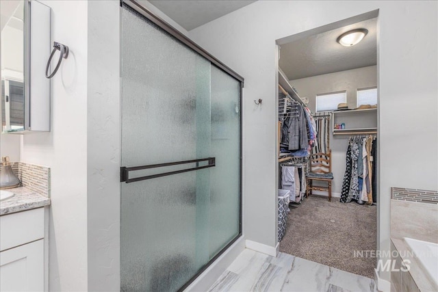 18272 N Wild Goose Ave, Nampa, ID 83687 - full bathroom featuring a spacious closet, a shower stall, vanity, marble finish floors, and baseboards