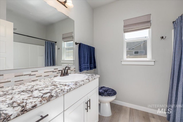 18272 N Wild Goose Ave, Nampa, ID 83687 - full bathroom with healthy amount of natural light, wood finished floors, vanity, and baseboards
