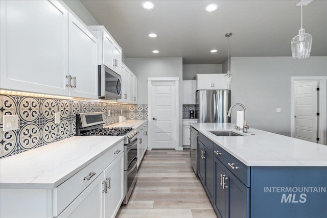 18272 N Wild Goose Ave, Nampa, ID 83687 - kitchen featuring stainless steel appliances, a sink, recessed lighting, white cabinets, and an island with sink