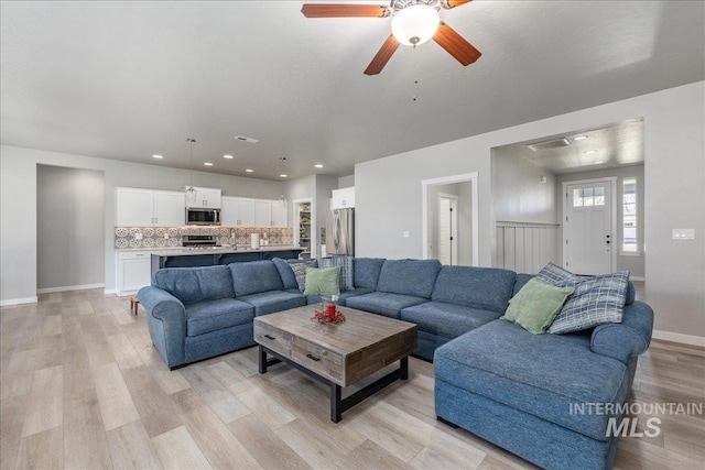 18272 N Wild Goose Ave, Nampa, ID 83687 - living room with light wood-type flooring, ceiling fan, baseboards, and recessed lighting
