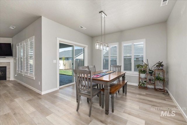 18272 N Wild Goose Ave, Nampa, ID 83687 - dining area featuring light wood finished floors, baseboards, and a chandelier