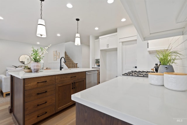 7766 W Daybreak Run Ct, Meridian, ID 83646 - kitchen with stainless steel dishwasher, light countertops, recessed lighting, decorative light fixtures, and white cabinetry