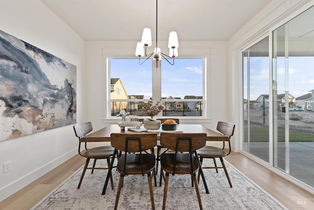 7766 W Daybreak Run Ct, Meridian, ID 83646 - dining area with a chandelier, light wood-style floors, and a residential view