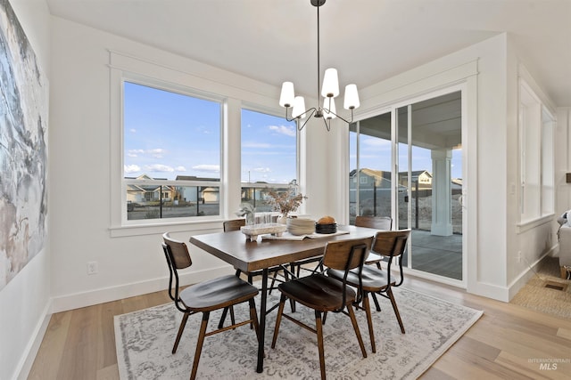 7766 W Daybreak Run Ct, Meridian, ID 83646 - dining space featuring a chandelier and light wood-style flooring