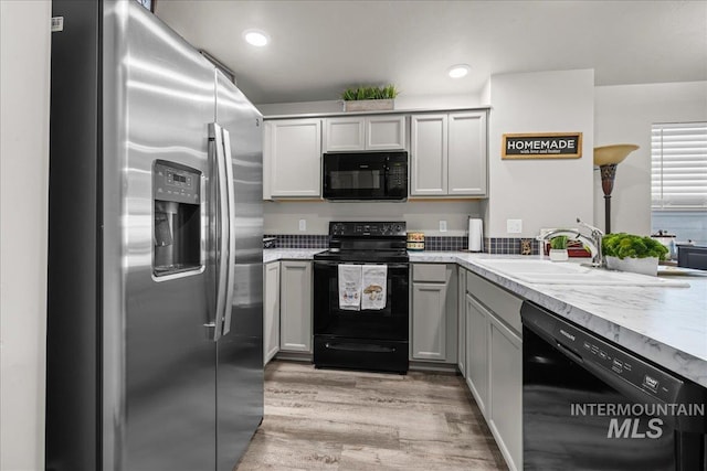 941 S Wavetrain Ave, Boise, ID 83709 - kitchen with black appliances, a sink, light wood-style flooring, light countertops, and gray cabinetry