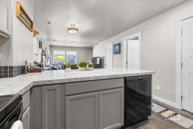 941 S Wavetrain Ave, Boise, ID 83709 - kitchen featuring black dishwasher, gray cabinets, a sink, and light countertops