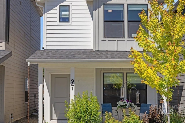 941 S Wavetrain Ave, Boise, ID 83709 - view of front of home with board and batten siding, a shingled roof, and a porch