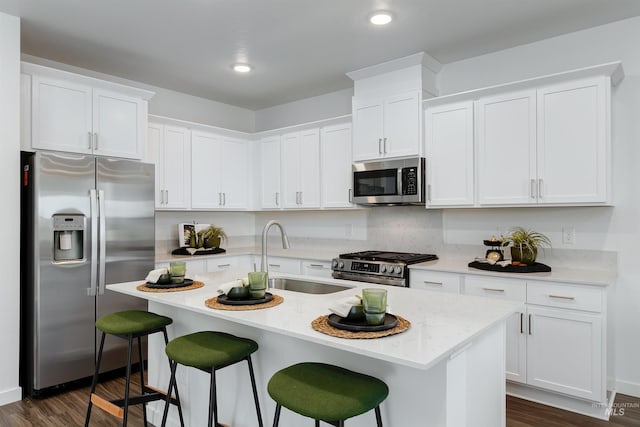 kitchen featuring a kitchen island with sink, white cabinetry, and appliances with stainless steel finishes