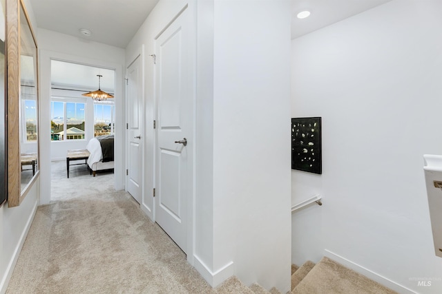 hallway featuring light carpet