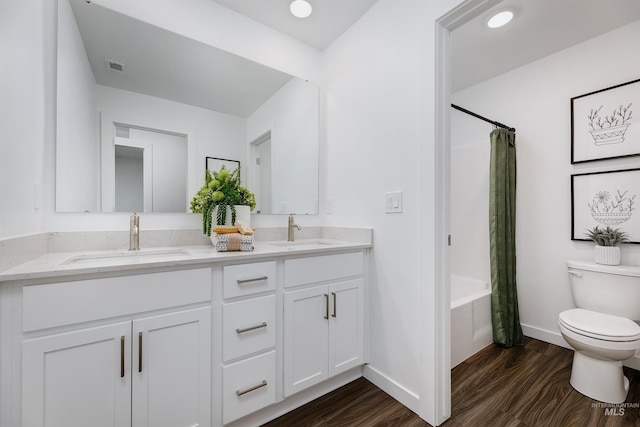 full bathroom with vanity, hardwood / wood-style floors, shower / tub combo with curtain, and toilet