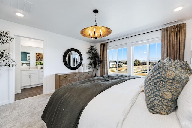 bedroom with connected bathroom, access to exterior, and dark carpet