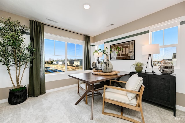 dining area with light colored carpet