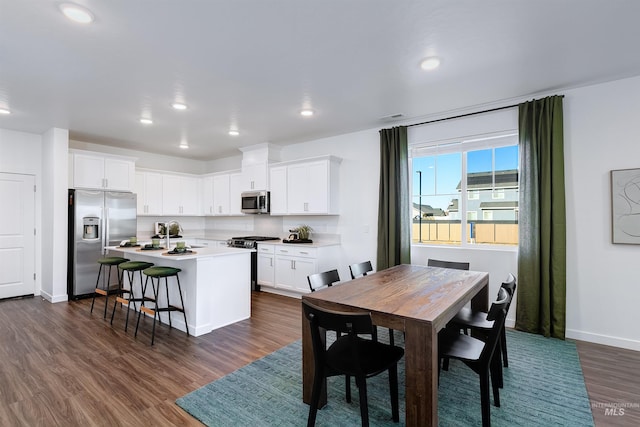 dining space featuring dark wood-type flooring and sink