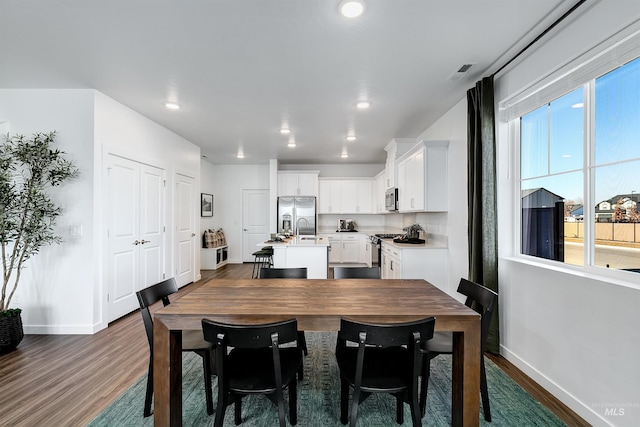 dining area with dark wood-type flooring