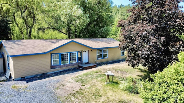 1089 Wallen Rd, Moscow, ID 83843 - view of front of house with crawl space, gravel driveway, and a view of trees