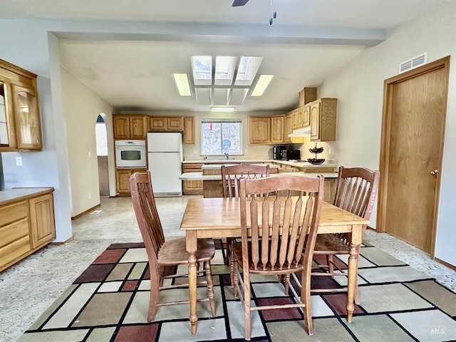 1089 Wallen Rd, Moscow, ID 83843 - dining space featuring a skylight, arched walkways, and a ceiling fan