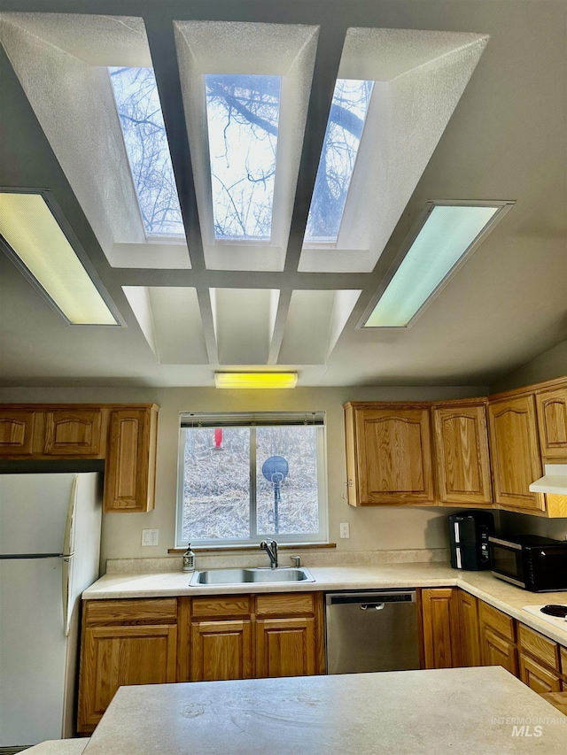 1089 Wallen Rd, Moscow, ID 83843 - kitchen with dishwasher, freestanding refrigerator, a skylight, and black microwave