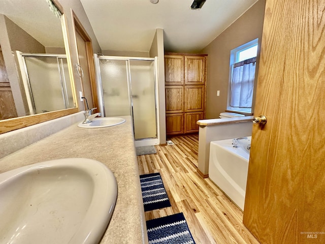 1089 Wallen Rd, Moscow, ID 83843 - bathroom featuring wood finished floors, a shower stall, a bath, and double vanity