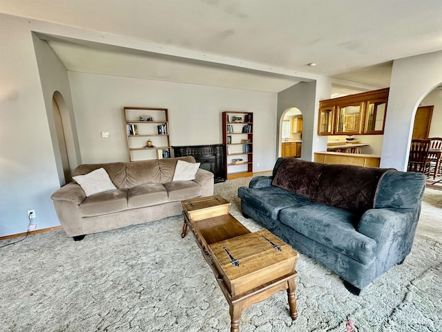 1089 Wallen Rd, Moscow, ID 83843 - living area featuring arched walkways, carpet, and a glass covered fireplace