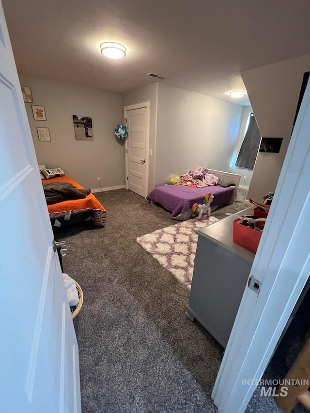 carpeted bedroom featuring visible vents