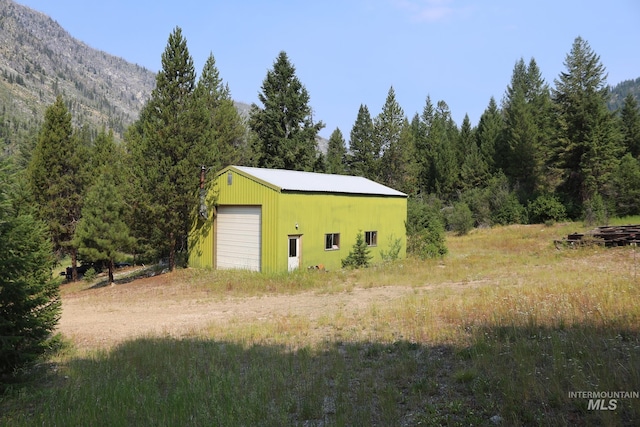 view of outbuilding with a mountain view and a garage