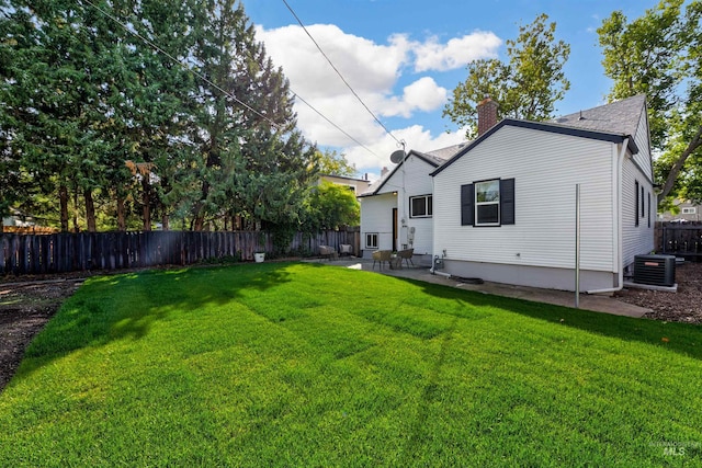 back of house featuring a yard, a patio area, and central air condition unit