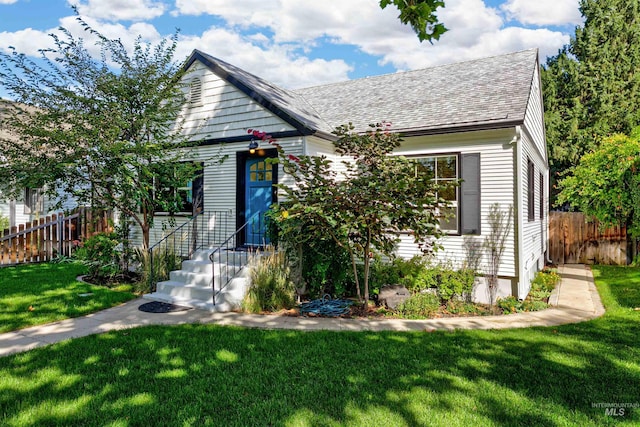 bungalow-style home with a front yard