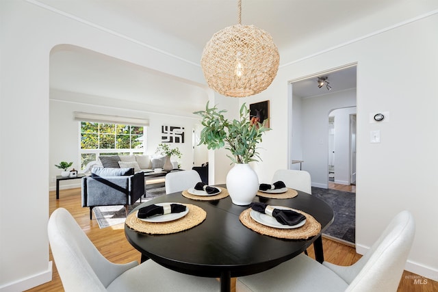 dining room featuring a chandelier and wood-type flooring