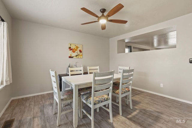 dining area with ceiling fan and hardwood / wood-style floors