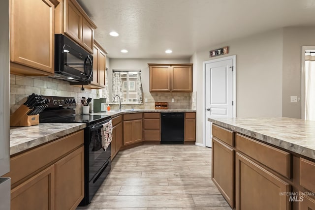 kitchen with light hardwood / wood-style flooring, sink, decorative backsplash, and black appliances