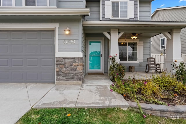 entrance to property with a garage and covered porch