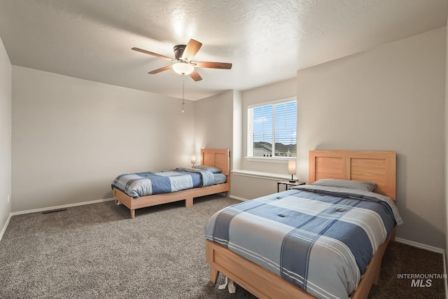 bedroom with ceiling fan, carpet, and a textured ceiling