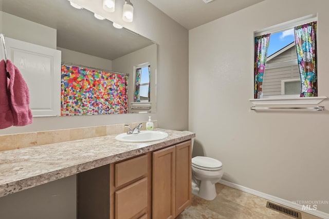 bathroom featuring vanity and toilet