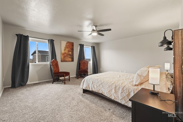 bedroom featuring multiple windows, carpet floors, and ceiling fan