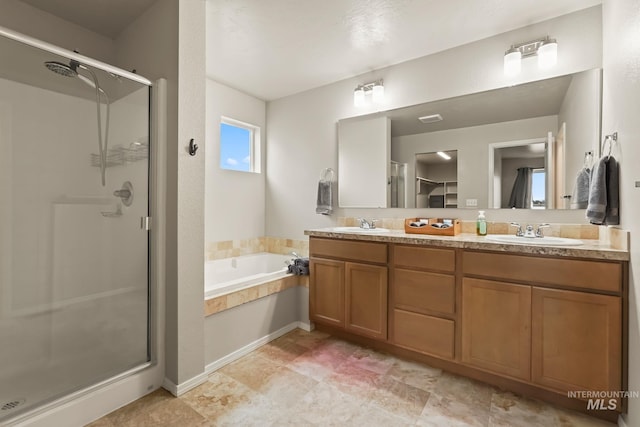 bathroom featuring vanity and separate shower and tub