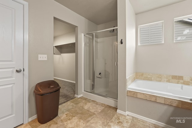 bathroom featuring independent shower and bath