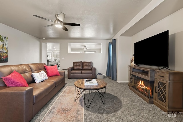 living room with ceiling fan and carpet floors