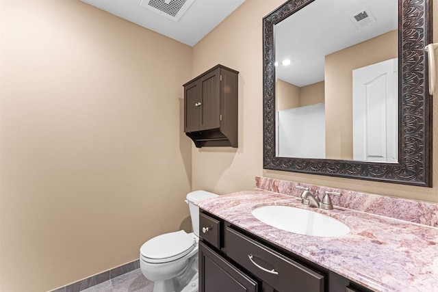 bathroom with toilet and vanity