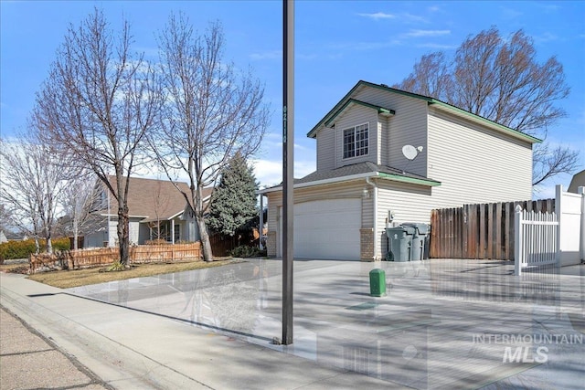 view of front of home with driveway and fence