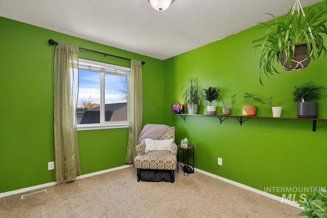 living area featuring carpet, visible vents, and baseboards